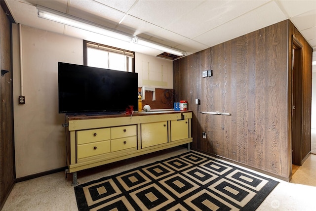 interior space with green cabinets, dark countertops, and wooden walls