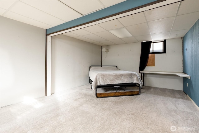 bedroom featuring carpet floors and a paneled ceiling