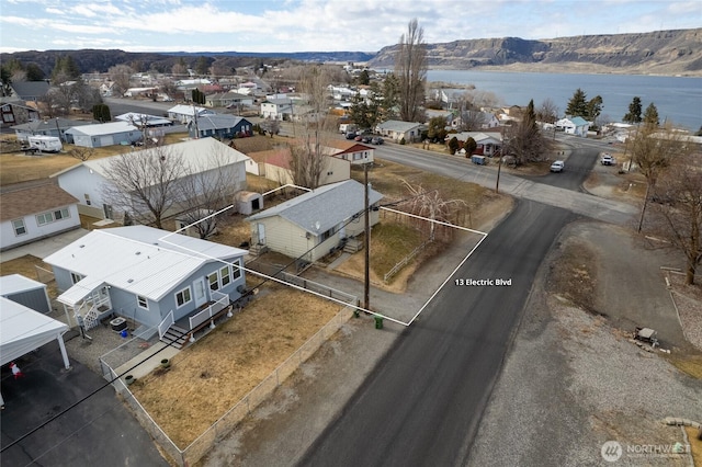 drone / aerial view with a residential view and a water and mountain view