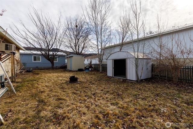 view of yard with a storage shed, an outdoor structure, and a fenced backyard