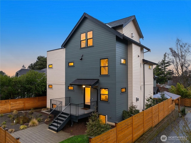 exterior space with stairway and a fenced backyard