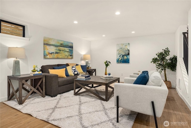 living room featuring light wood-style floors, baseboards, and recessed lighting