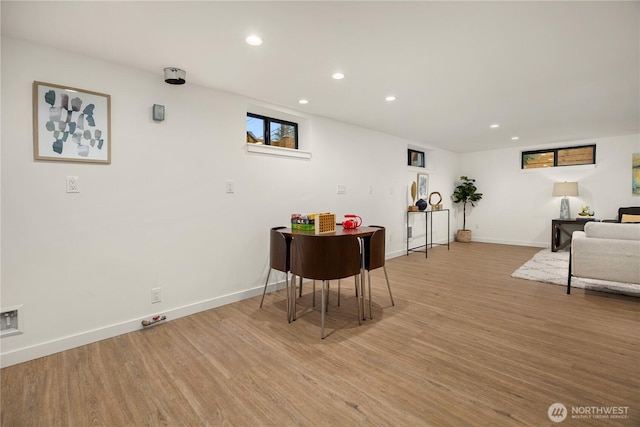 dining area featuring light wood-style flooring, baseboards, and recessed lighting