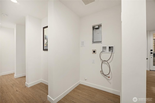 clothes washing area featuring washer hookup, laundry area, hookup for an electric dryer, and light wood finished floors