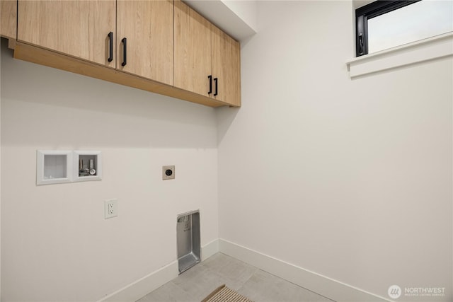 laundry area featuring hookup for a washing machine, cabinet space, hookup for an electric dryer, and baseboards