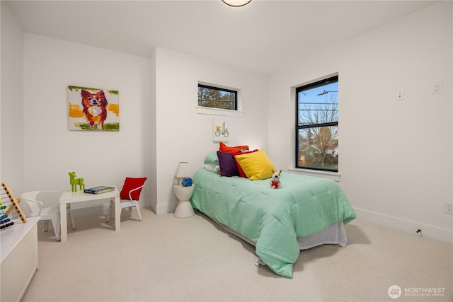 carpeted bedroom featuring baseboards