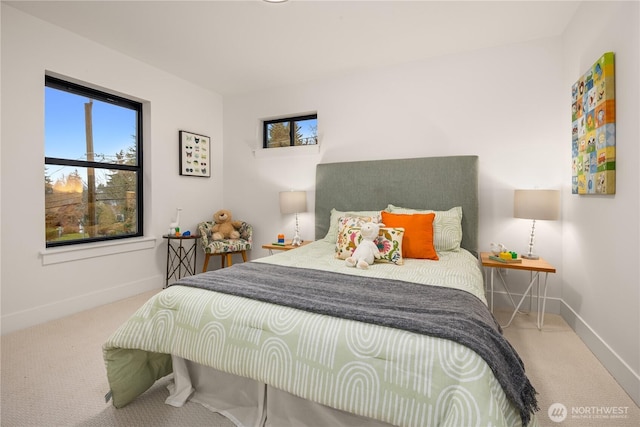 carpeted bedroom featuring baseboards