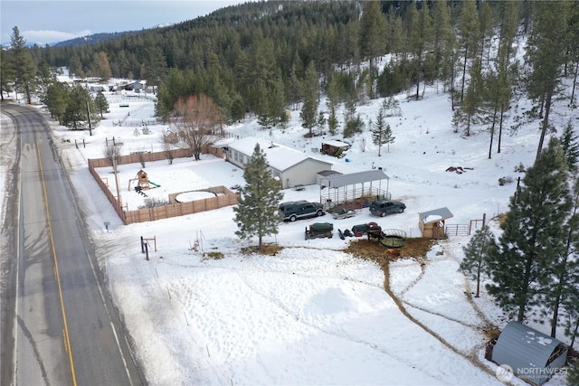 snowy aerial view with a forest view