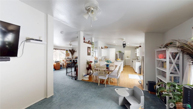 dining room featuring light carpet and ceiling fan