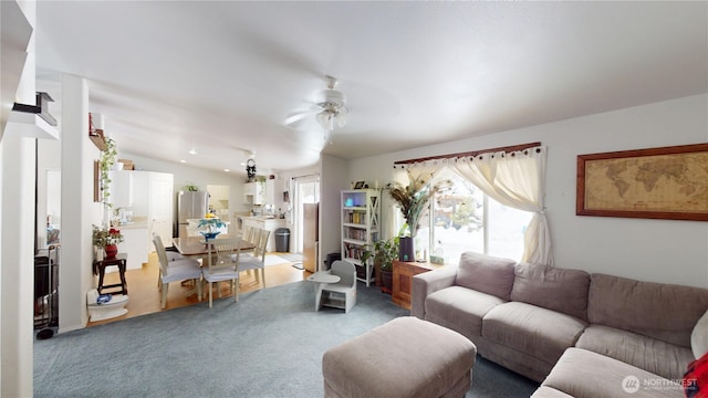 living room featuring carpet, vaulted ceiling, and a ceiling fan