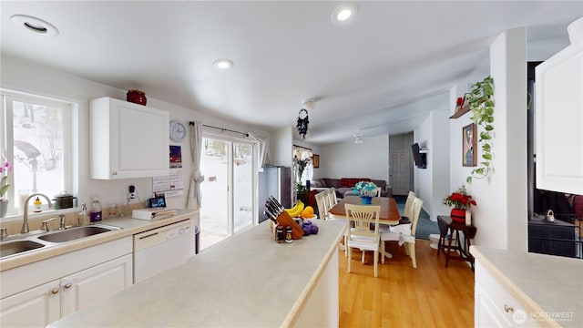 kitchen featuring white cabinetry, light countertops, and dishwasher