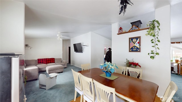 carpeted dining area featuring a ceiling fan