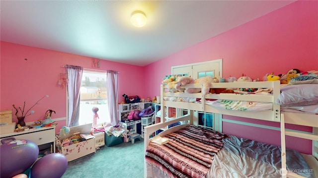 bedroom featuring carpet flooring and vaulted ceiling