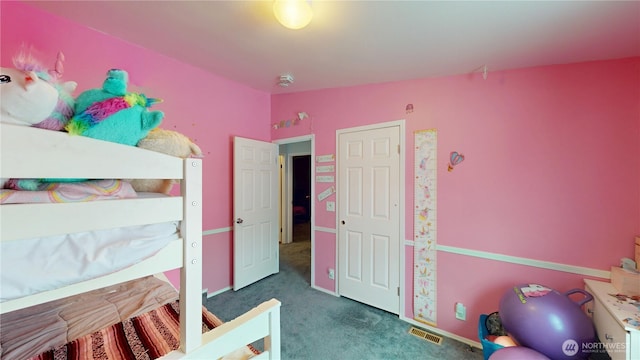 bedroom with dark colored carpet, visible vents, and lofted ceiling