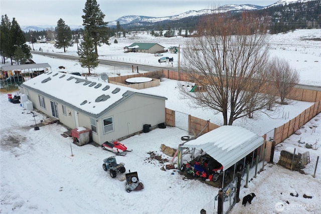 snowy aerial view featuring a mountain view