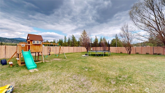 722 Aeneas Valley Rd, Tonasket, WA 98855 - view of yard with a fenced backyard, a playground, and a trampoline
