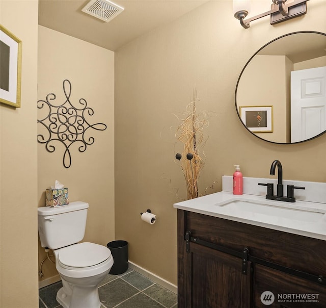 bathroom with visible vents, toilet, tile patterned flooring, baseboards, and vanity