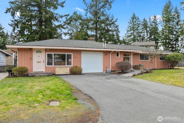 ranch-style home featuring driveway, a front lawn, board and batten siding, a garage, and a chimney