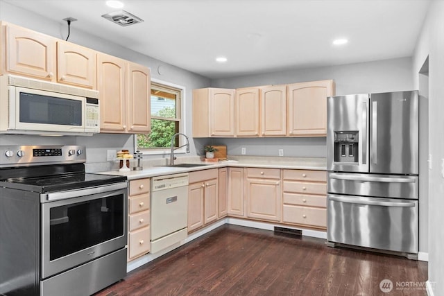 kitchen featuring visible vents, light brown cabinets, light countertops, appliances with stainless steel finishes, and a sink