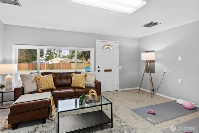 living area with visible vents, baseboards, and carpet