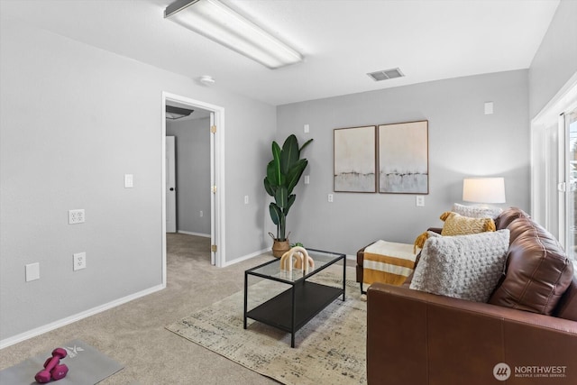 living area with visible vents, baseboards, and light colored carpet