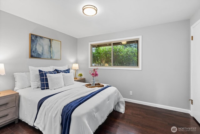 bedroom featuring baseboards and wood finished floors