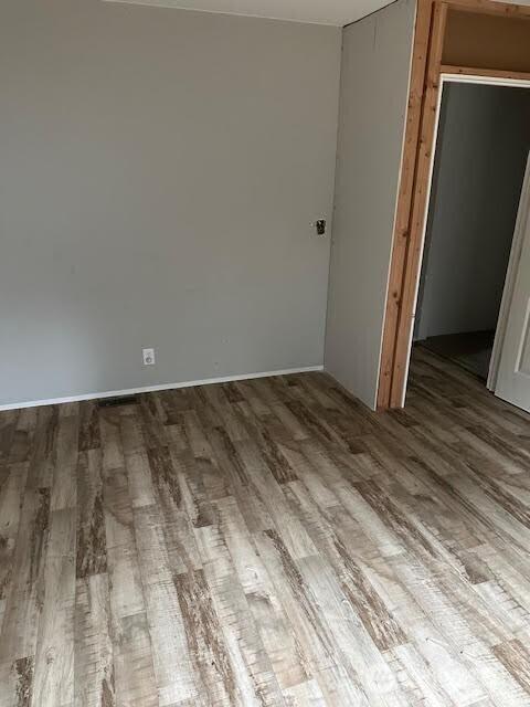 spare room featuring wood finished floors