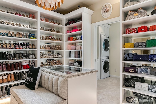 pantry with stacked washer and clothes dryer