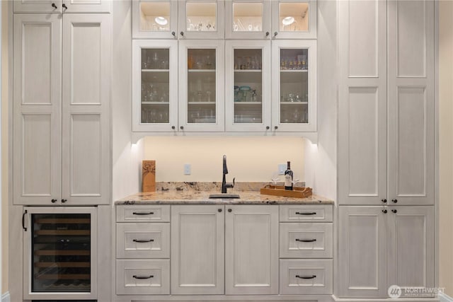 bar featuring wine cooler and a sink