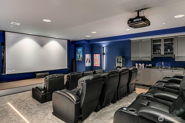 cinema room featuring indoor wet bar, recessed lighting, visible vents, light carpet, and a sink