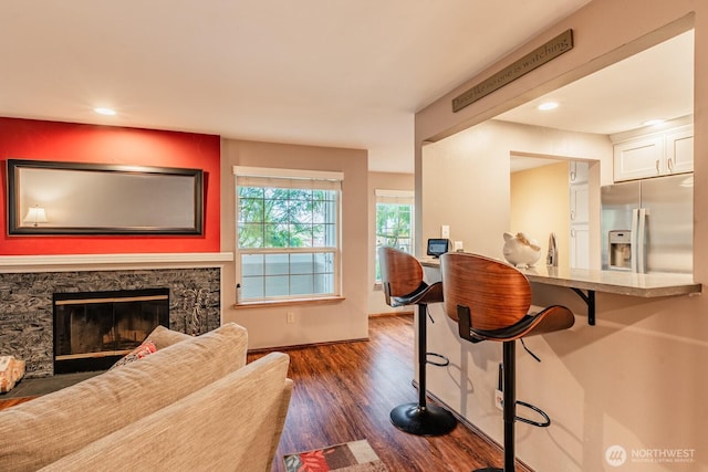 interior space with dark wood-style floors, a fireplace, and recessed lighting