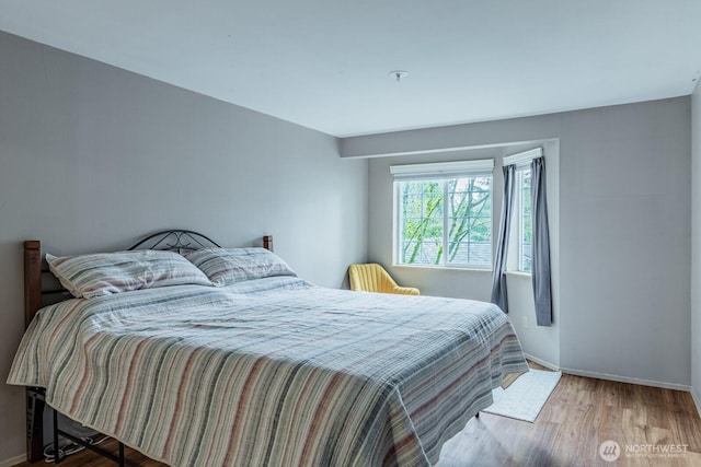 bedroom featuring baseboards and wood finished floors