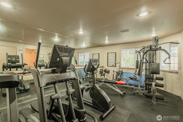 exercise room with baseboards and recessed lighting