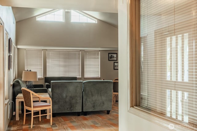 living area with high vaulted ceiling