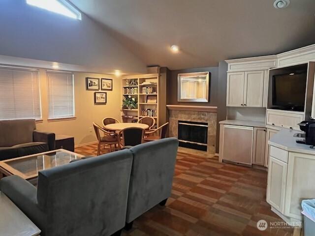 living area with lofted ceiling and a fireplace