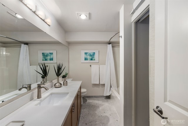 full bath featuring concrete floors, shower / tub combo with curtain, vanity, and toilet