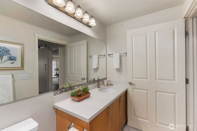 bathroom with vanity and toilet