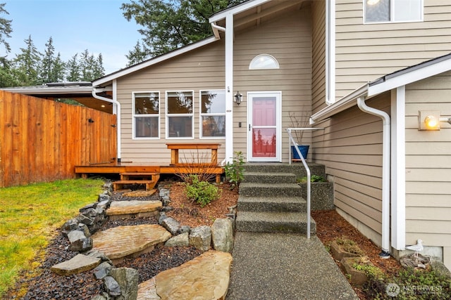 entrance to property with fence and a wooden deck