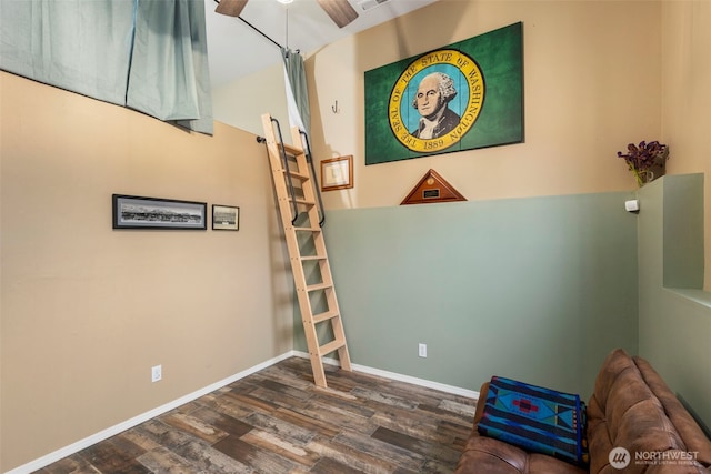 interior space with dark wood-style floors, ceiling fan, and baseboards