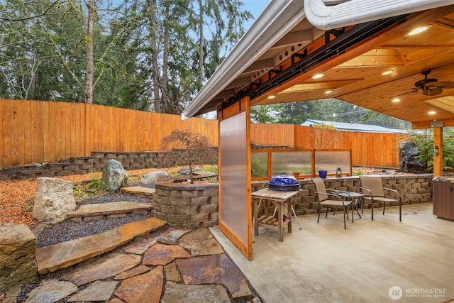 view of patio / terrace featuring ceiling fan, a sink, and a fenced backyard