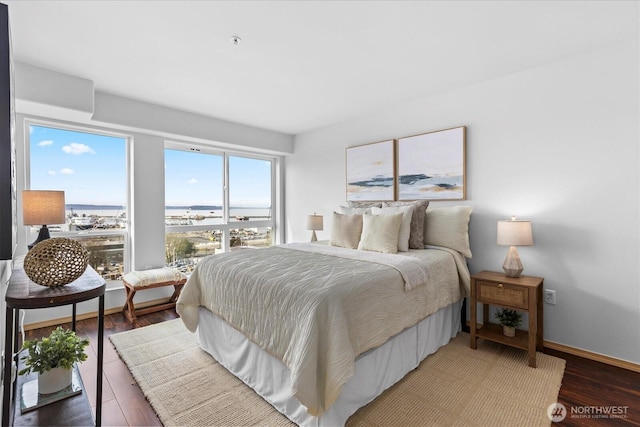 bedroom with light wood-type flooring and baseboards