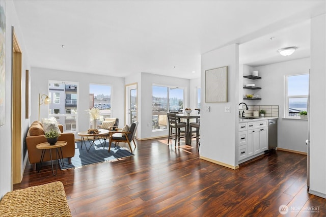 interior space with dark wood-style flooring and baseboards