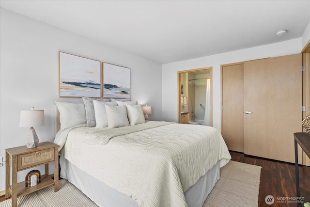 bedroom with wood finished floors and ensuite bathroom