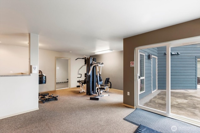 exercise area featuring carpet floors and baseboards