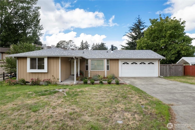 ranch-style house featuring a garage, concrete driveway, fence, board and batten siding, and a front yard