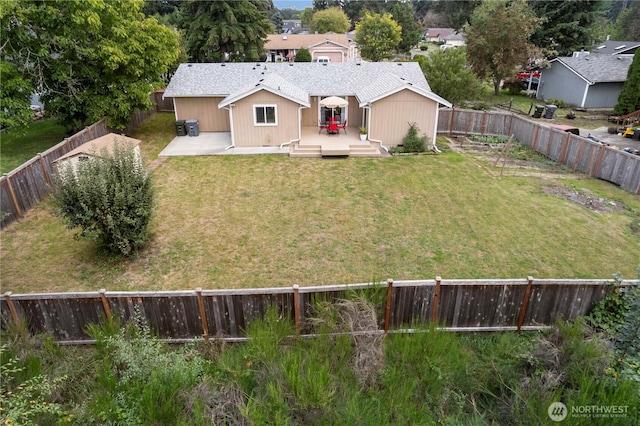 rear view of property with a fenced backyard, a lawn, and a wooden deck