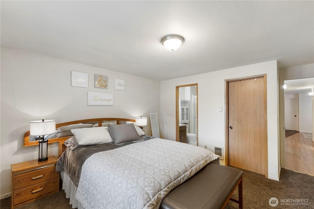 bedroom featuring a closet, visible vents, and dark carpet