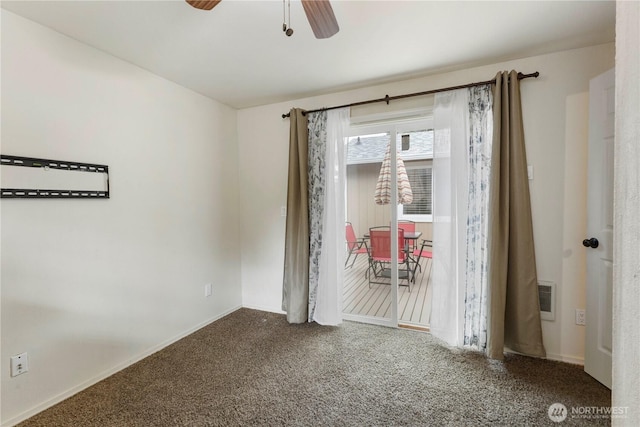 carpeted empty room featuring ceiling fan and visible vents