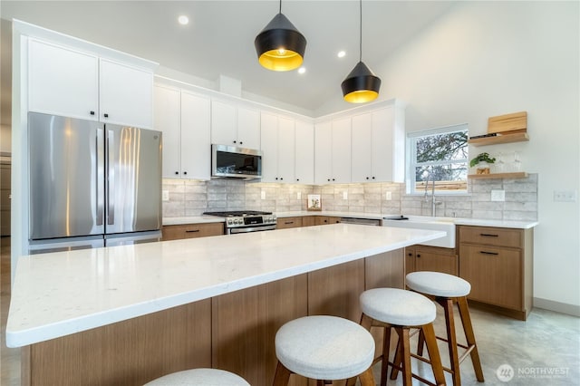 kitchen featuring stainless steel appliances, white cabinetry, a sink, and tasteful backsplash