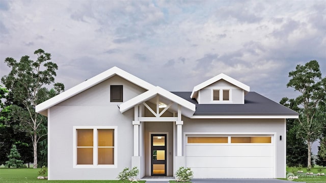 view of front of home with driveway, a front lawn, and stucco siding